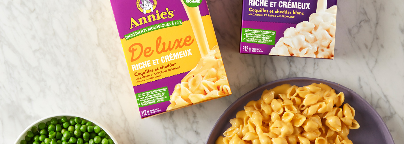 Annie's Deluxe Mac n Cheese, front of box next to a bowl of mac n cheese