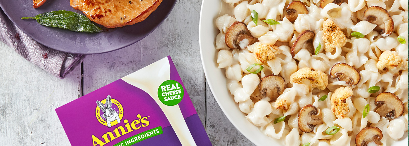 A bowl of Annie's Deluxe Rich & Creamy Shells & White Cheddar with mushrooms and cauliflower